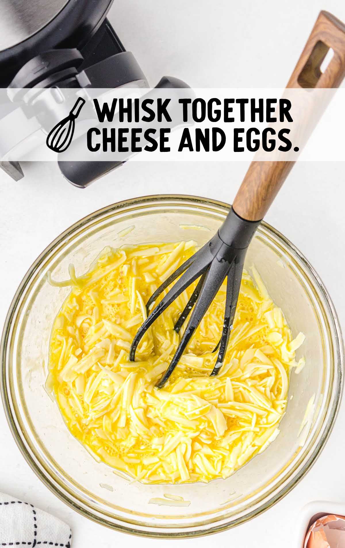 cheese and eggs whisked together in a bowl
