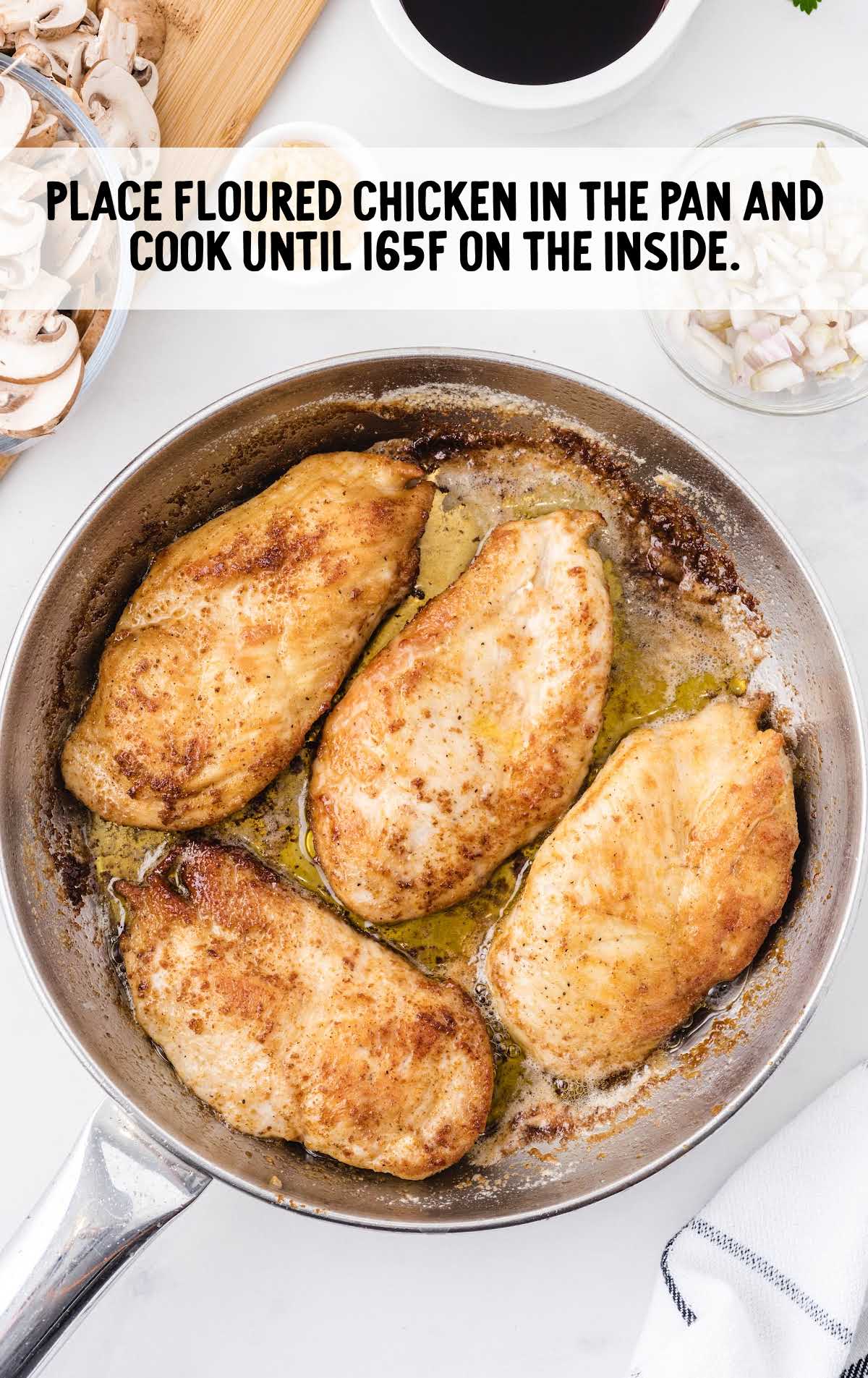 chicken being cooked in a pan