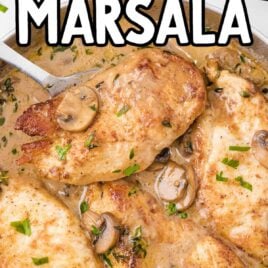 close up shot of chicken marsala with sauce and mushrooms on top in a dish