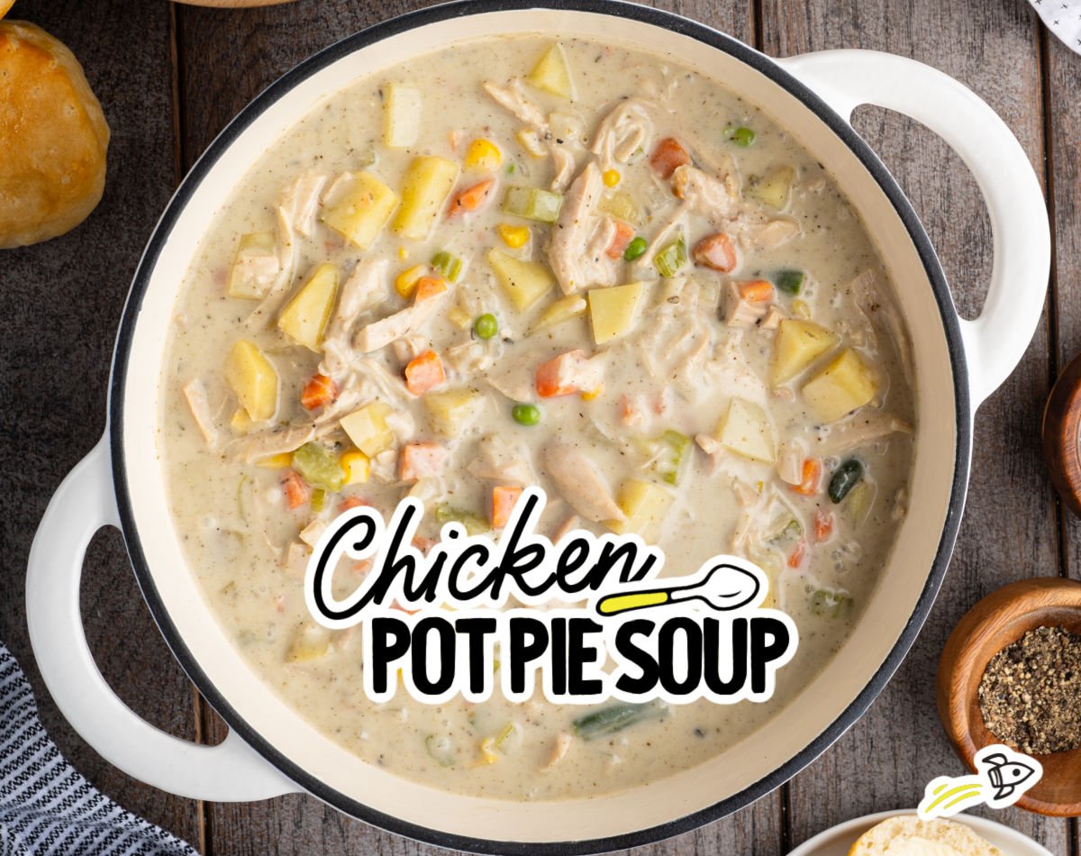 Dutch oven filled with thick chicken pot pie soup with chicken, potatoes, and vegetables.