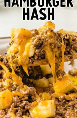 hamburger hash topped with cheddar cheese in a skillet with a wooden spoon