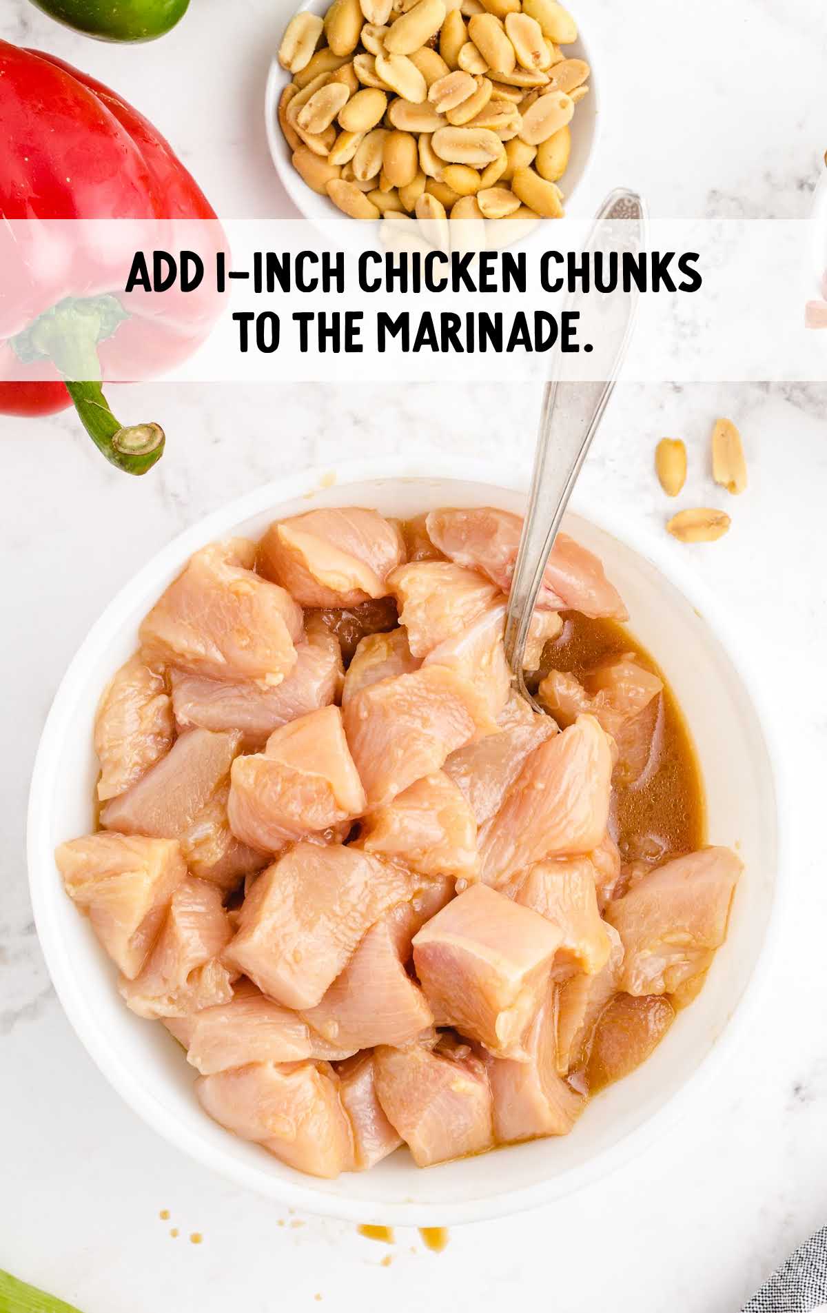 chicken chunks added to the marinade in a bowl