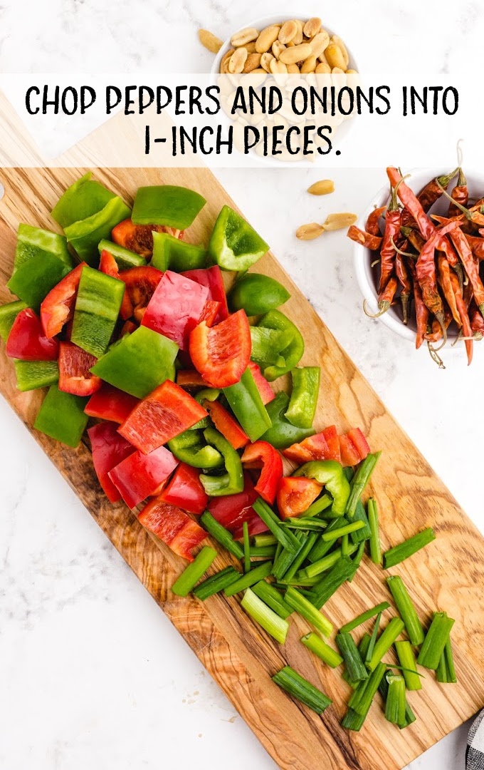 peppers and onion chopped on a wooden board