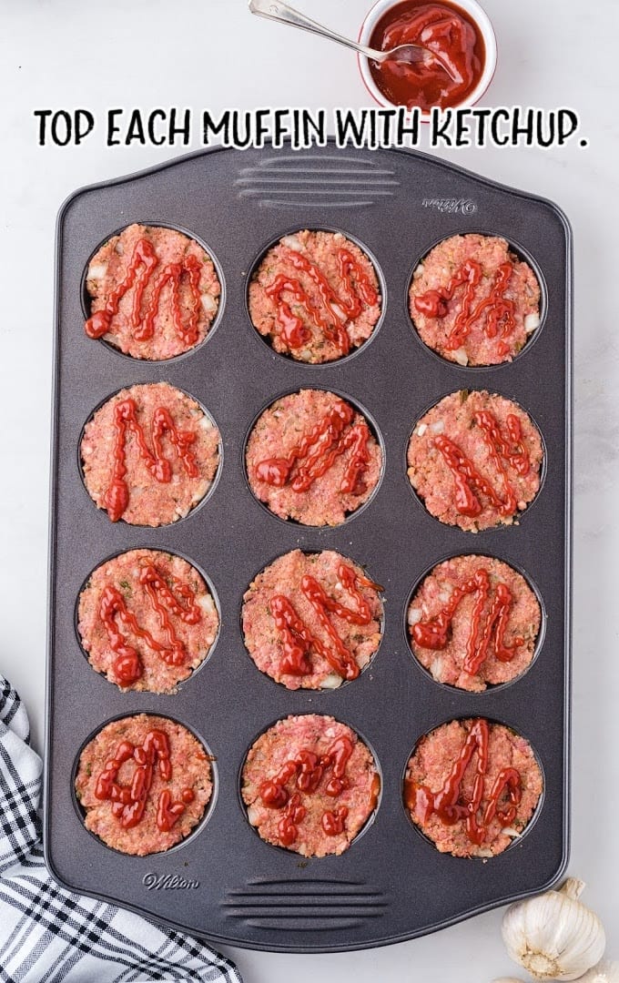 muffin pan meatloaf process shot of being topped with ketchup