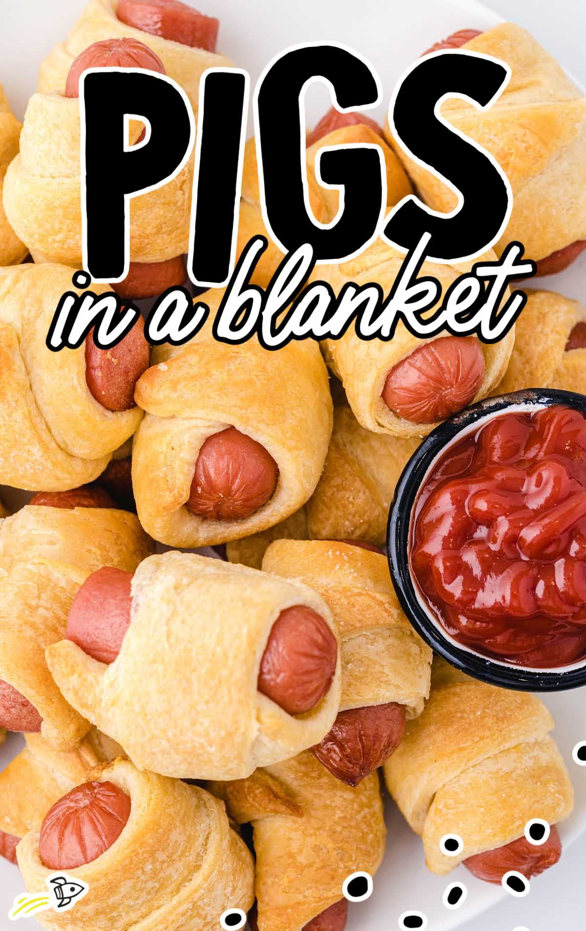 close up shot of multiple Pigs in a Blanket with ketchup on the side