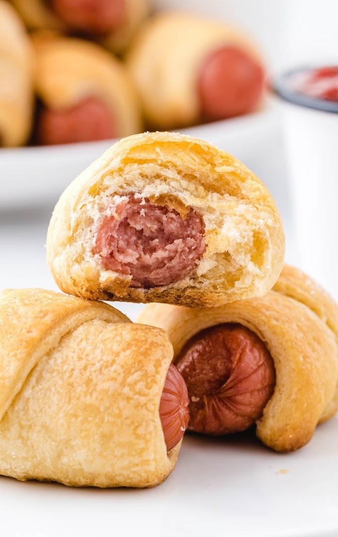 close up shot of pigs in a blanket on a white plate
