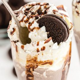 close up shot of Oreo milkshake topped with a Oreo and chocolate glaze