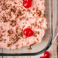 close up shot of cherry dr pepper cake in a clear baking pan