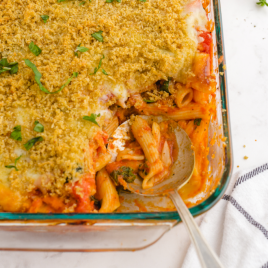 close up shot of chicken parmesan casserole in a clear baking dish