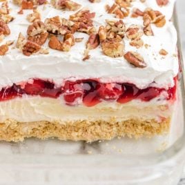 close up shot of cherry cheesecake lush with walnuts on top in a dish