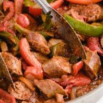 close up shot of sausage and peppers in a dish