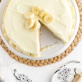 close up overhead shot of banana cake with a slice cut out on a cake tray