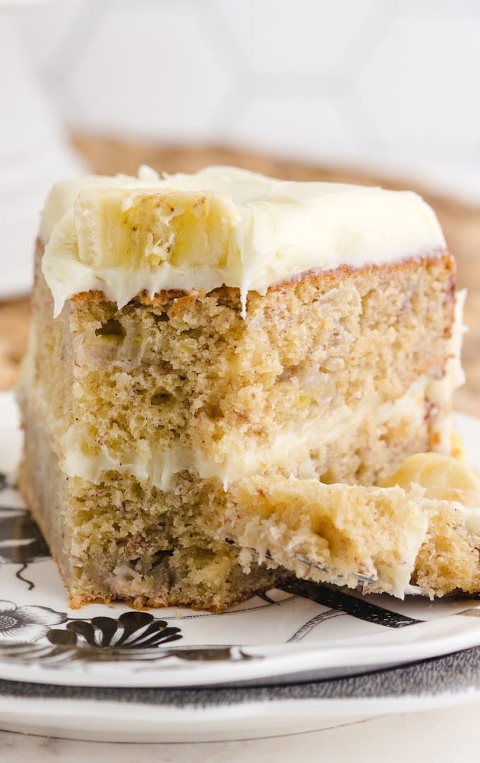 close up front shot of a slice of banana cake on a plate