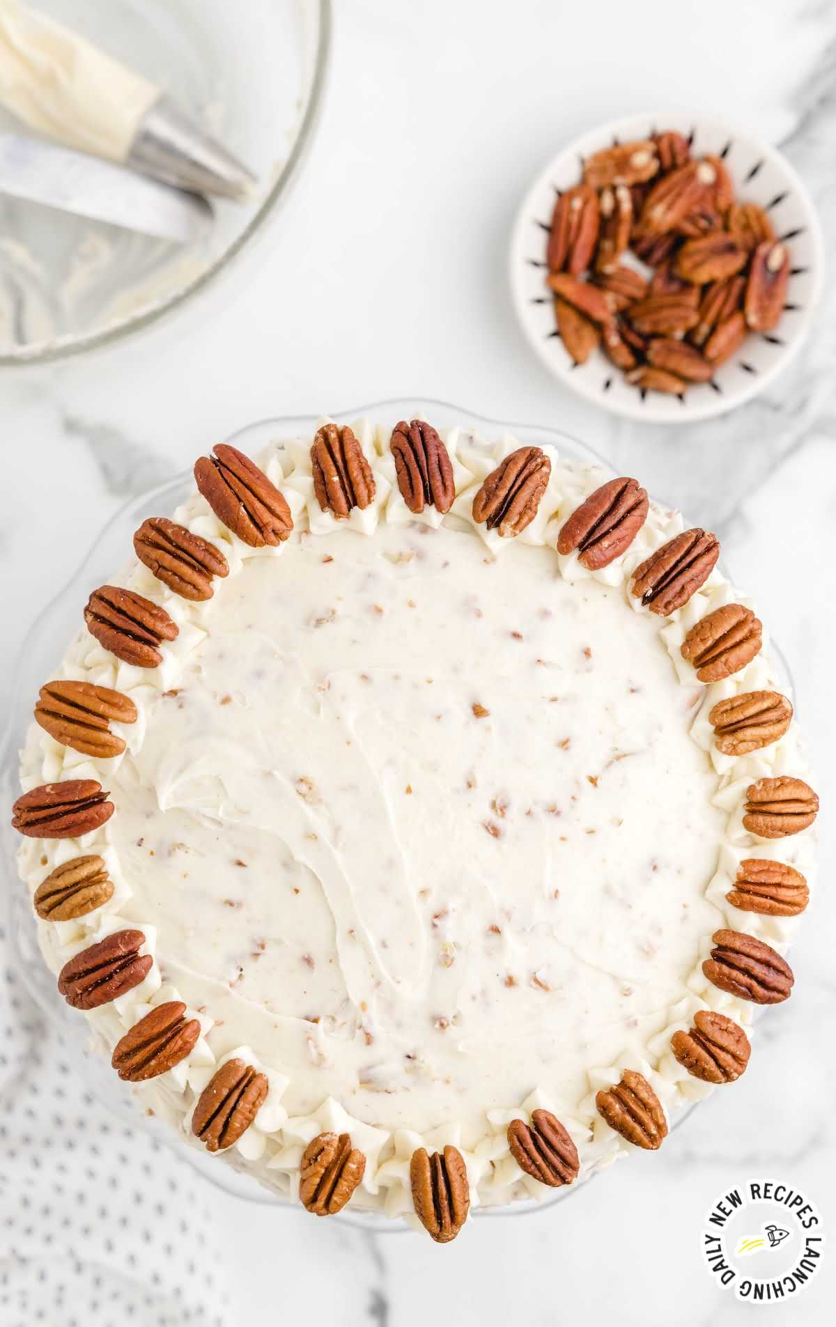 overhead shot of carrot cake cheesecake with pecans on top