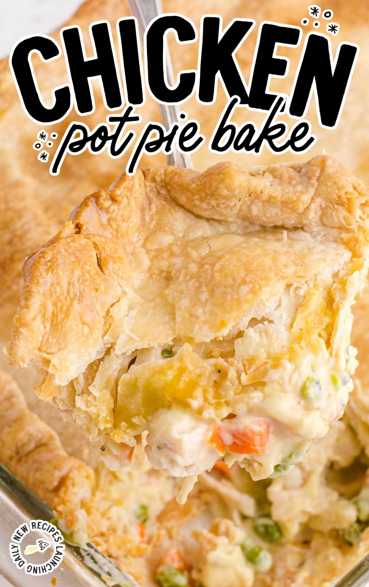 Slice of chicken pot pie being lifted from a baking dish, showing golden flaky crust and creamy filling with peas and carrots.