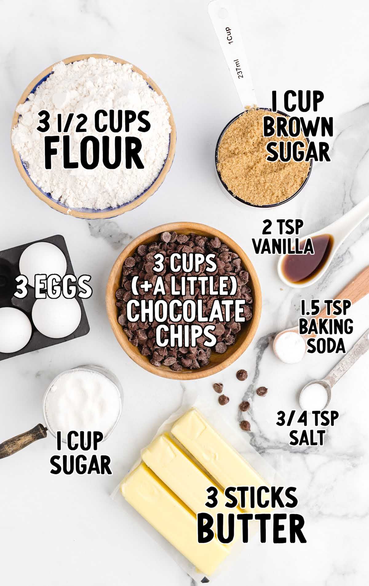 Flat lay of chocolate chip cookie bar ingredients labeled with text, including flour, sugar, eggs, and vanilla.