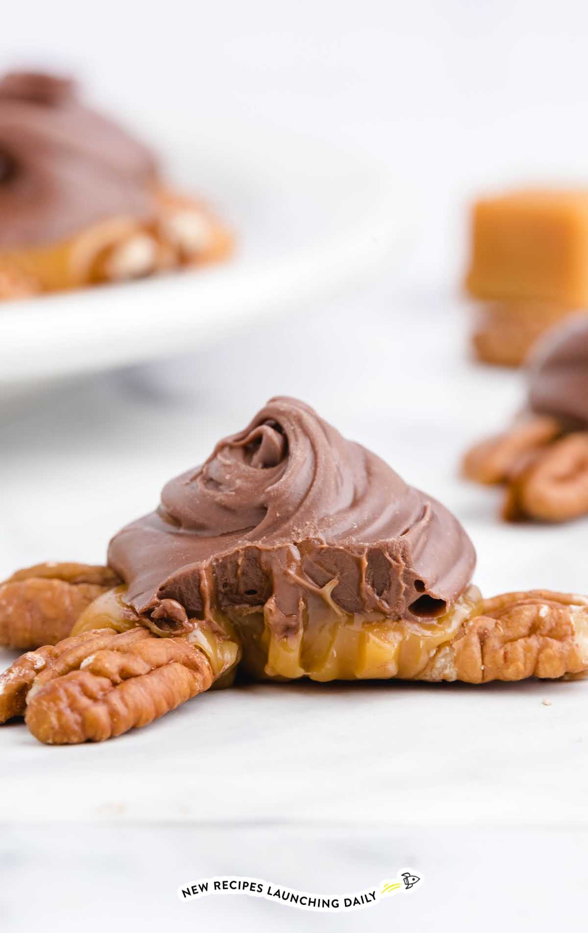close up shot of Chocolate Turtles with a bite taken out of it