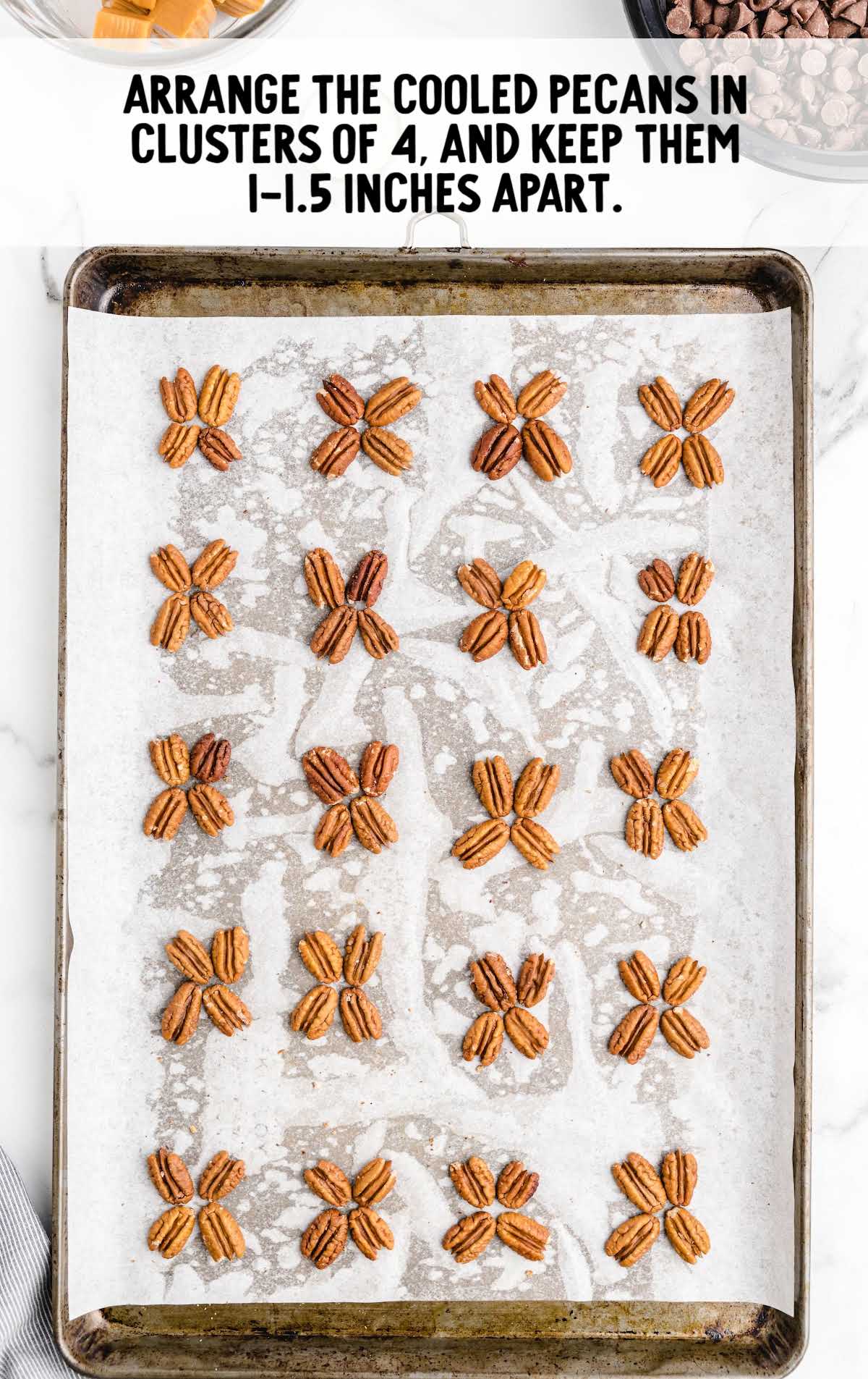 pecans added into clusters on a baking sheet