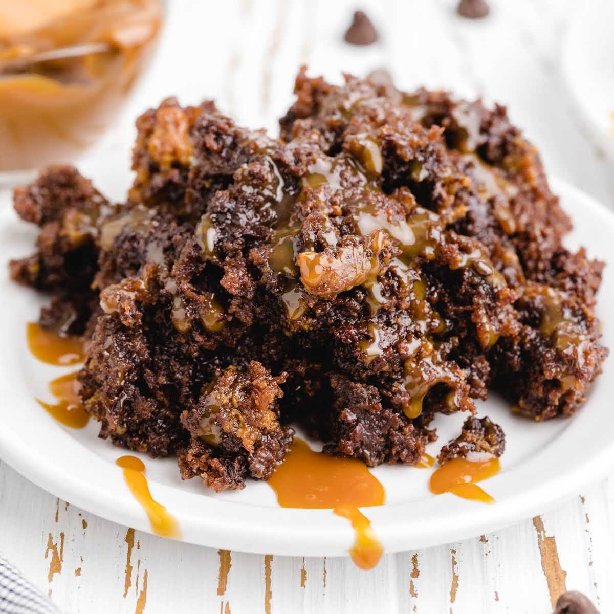 close up shot of a plate of Crockpot Chocolate Caramel Cake drizzled with caramel syrup