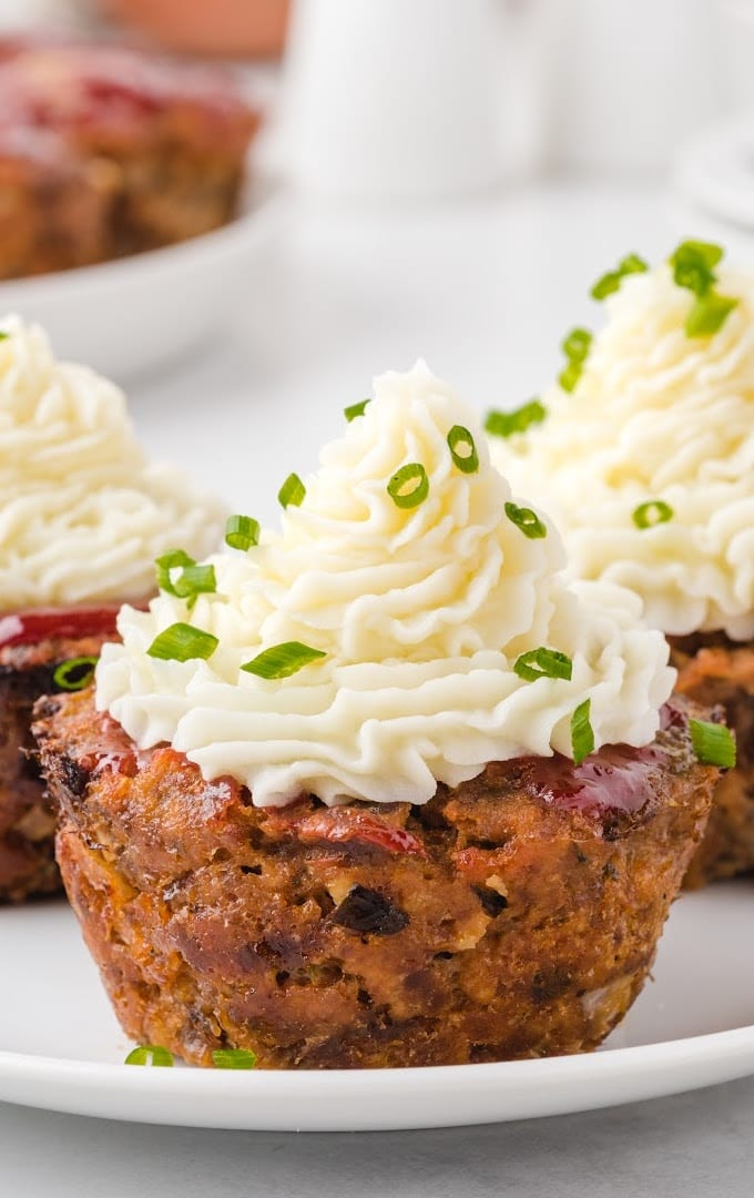 close up shot of muffin pan meatloaf with mashed potatoes icing on top