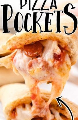 close up shot of pizza pockets pulled apart showing its gooey insides on a board