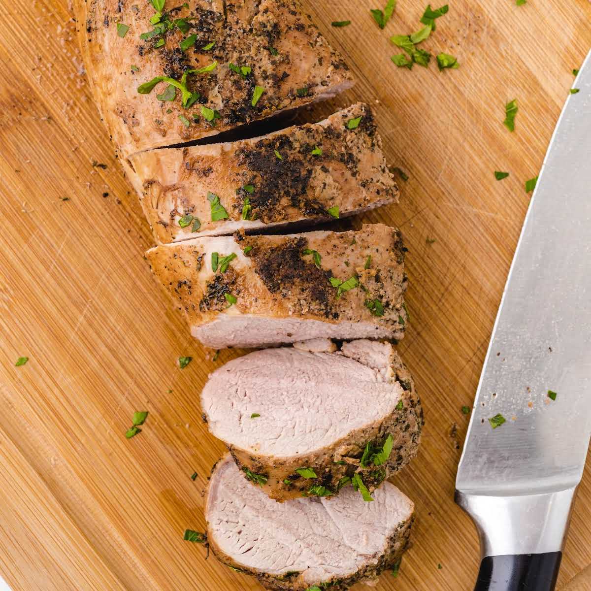over head shot of Pork Tenderloin sliced on a cutting board