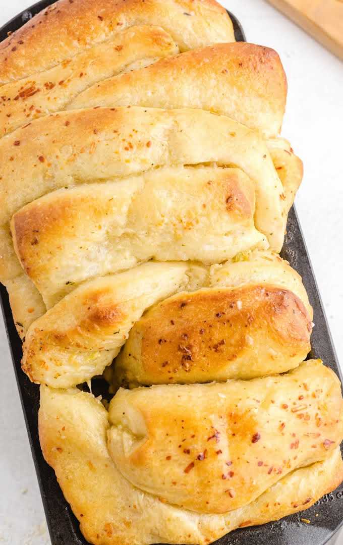 overhead shot of pull-apart garlic bread on a pan