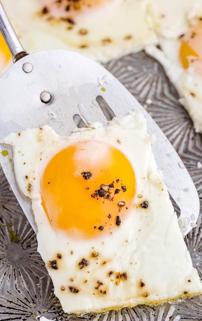 close up shot of a piece of sheet pan eggs on a spatula