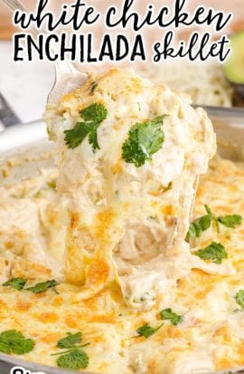 White Chicken Enchiladas Skillet with cheese being scooped from the pan
