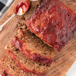 close up overhead shot of slices of meatloaf on a wooden board