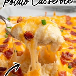 A fork lifts a cheesy, gooey bite of Twice Baked Potato Casserole topped with melted cheese, crispy bacon, and green onions from a dish. Text reads: The Best Twice Baked Potato Casserole Recipe—packed with tons of flavor!.