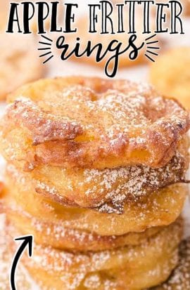 apple fritter rings stacked on top of each other and drizzled with powder sugar