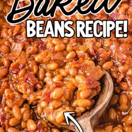 close up overhead shot of a baking dish of Baked Beans with a wooden spoon