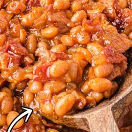 close up shot of Baked Beans with a wooden spoon