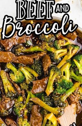 close up overhead shot of beef and broccoli in a pan with a wooden spoon