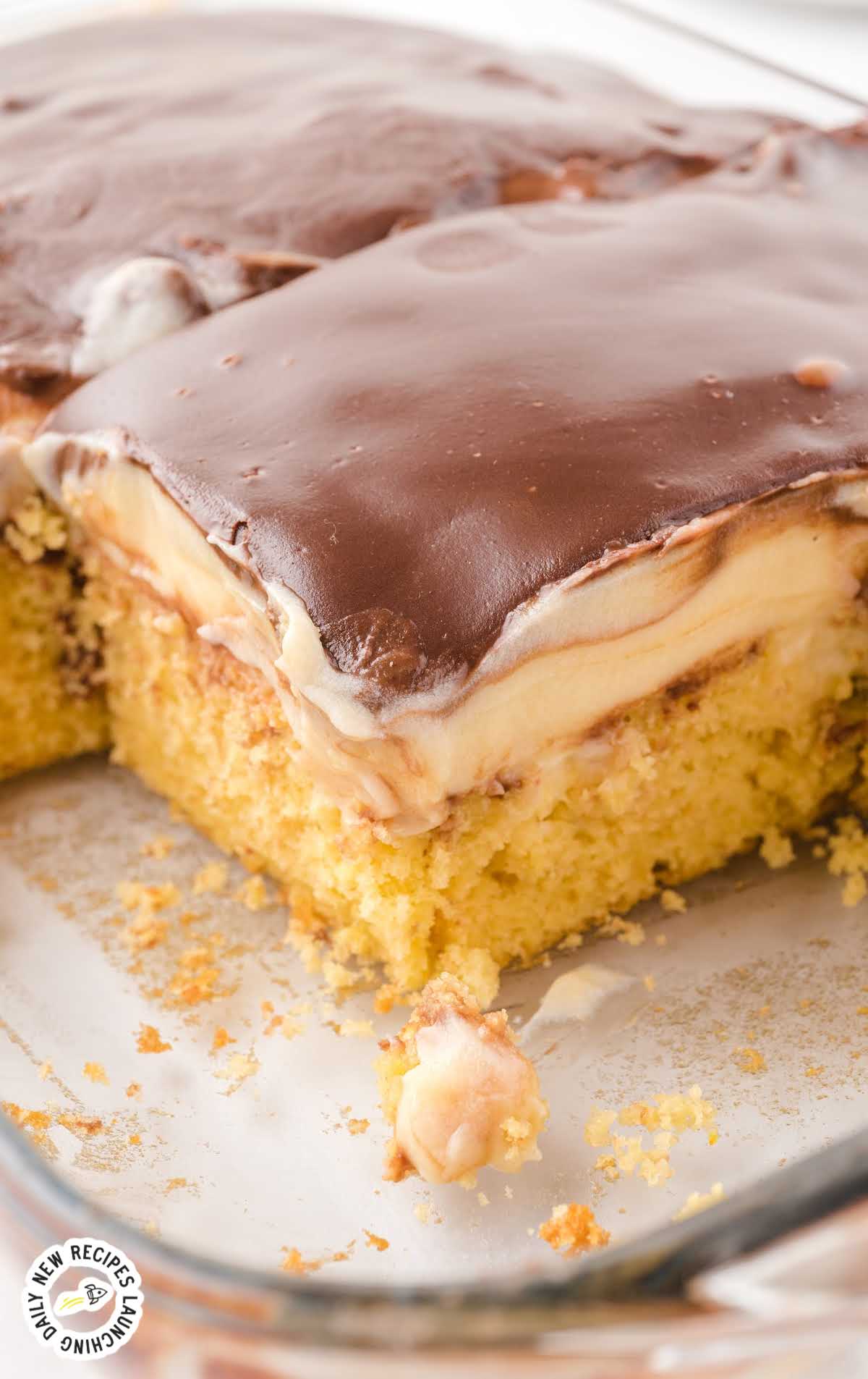 close up shot of a cake in a baking dish with slices of cake missing