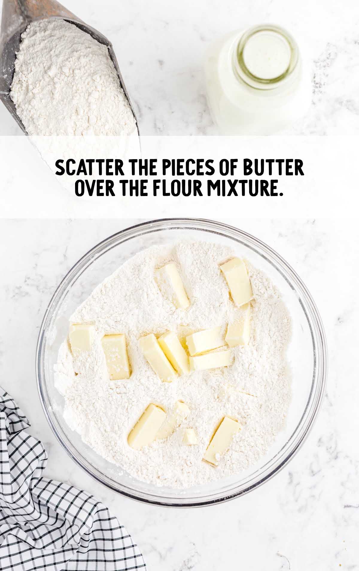pieces of butter added to the flour mixture in a bowl