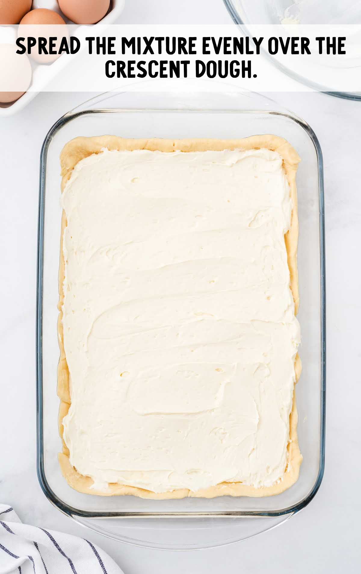 cream cheese mixture spread over the dough in a baking dish