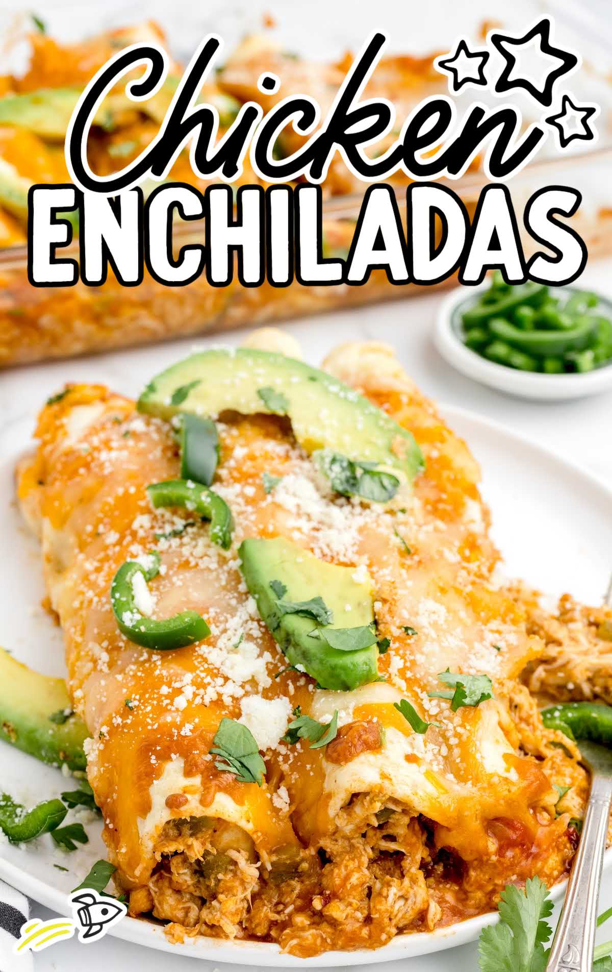 close up shot of a plate of Chicken Enchiladas garnished with sliced avocados and peppers