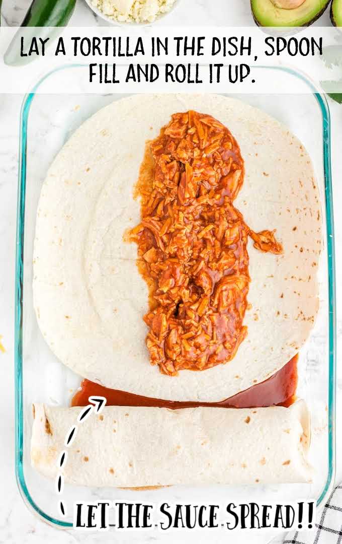 chicken enchiladas process shot of meat being spooned onto a tortilla then rolled