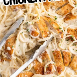 creamy chicken pasta with linguini and sliced chicken in parmesan cream sauce in skillet