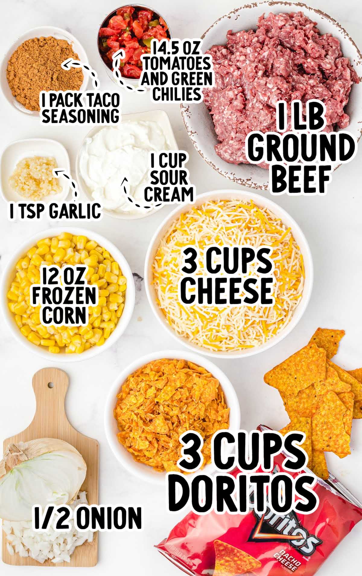 Overhead view of labeled ingredients for Dorito casserole including ground beef, tomatoes with green chiles, cheese, corn, sour cream, Doritos, and seasonings.