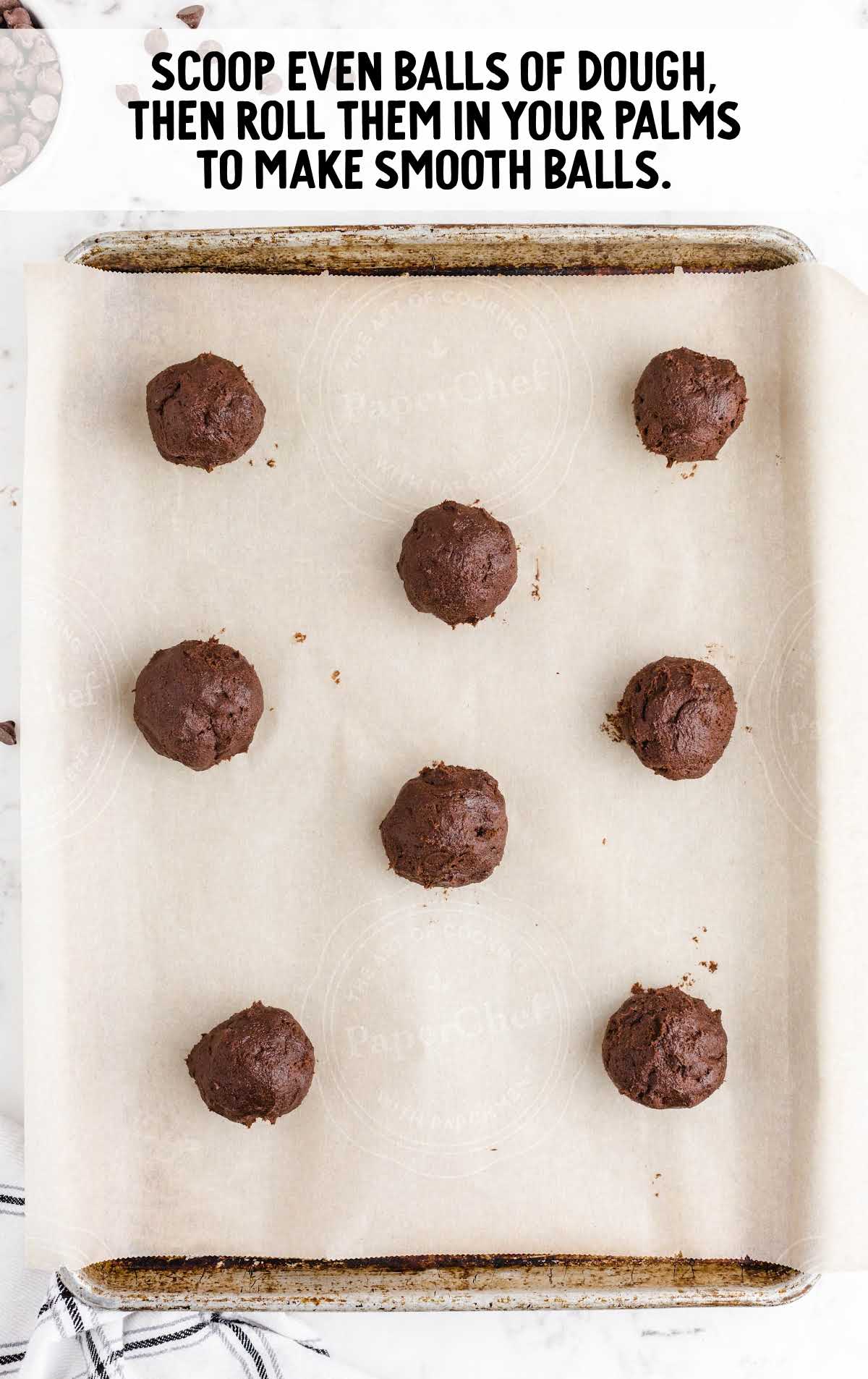 double chocolate chip cookies process shot of dough being rolled into balls and placed onto baking dish