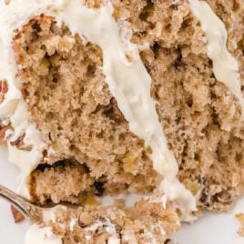 a close up shot of a slice of Hummingbird Cake on a plate