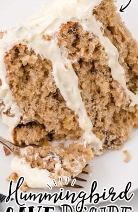 close up shot of a slice of hummingbird cake on a plate with a fork