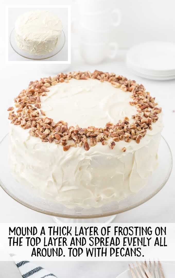 hummingbird cake process shot of cake spread with frosting and topped with pecans