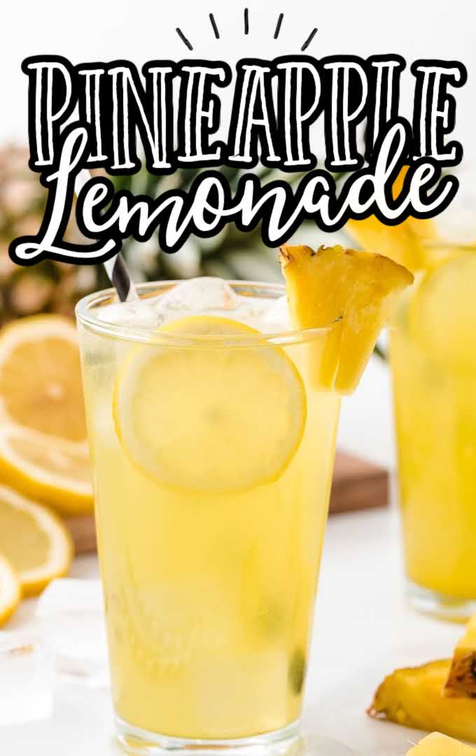 a glass of pineapple lemonade with ice and lemon and pineapple slices
