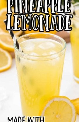 a glass of pineapple lemonade with ice and lemon slices
