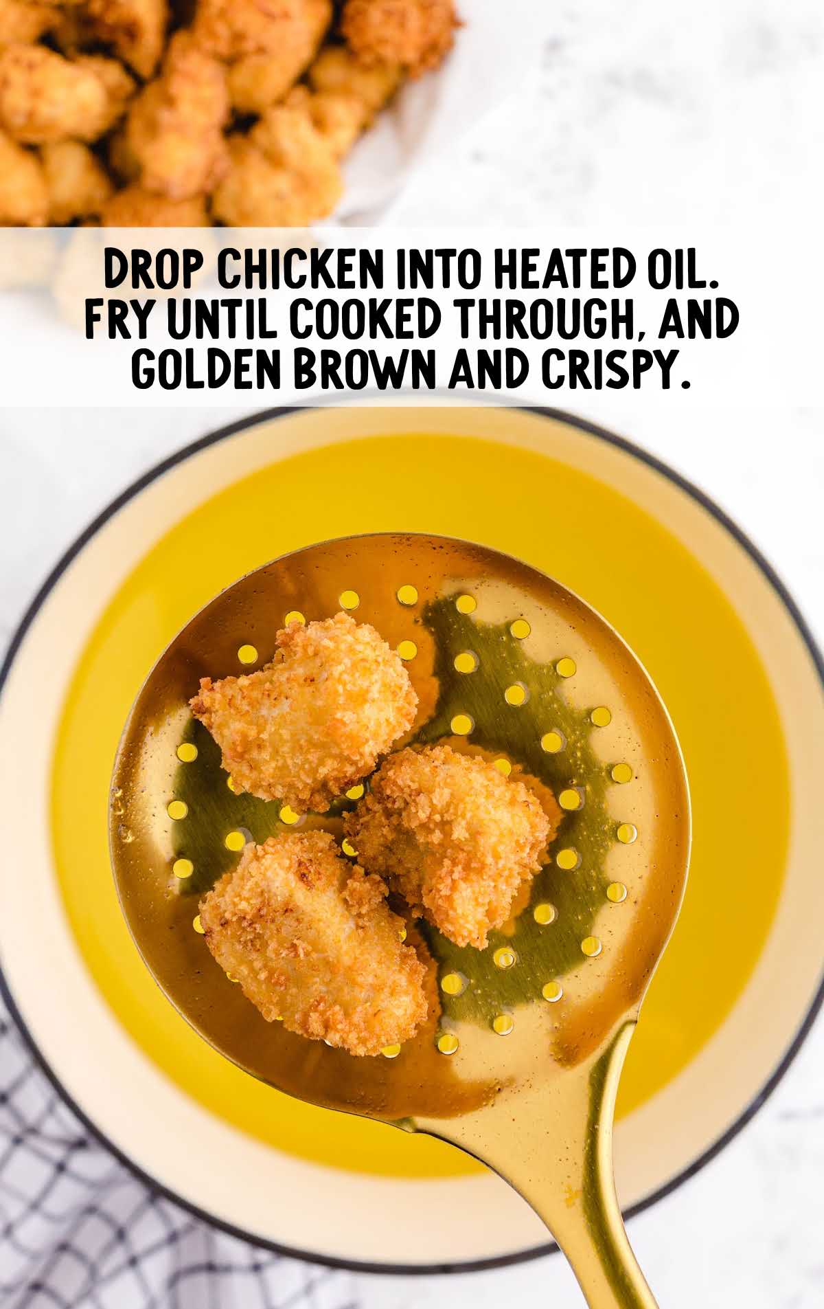 chicken dropped into heated oil