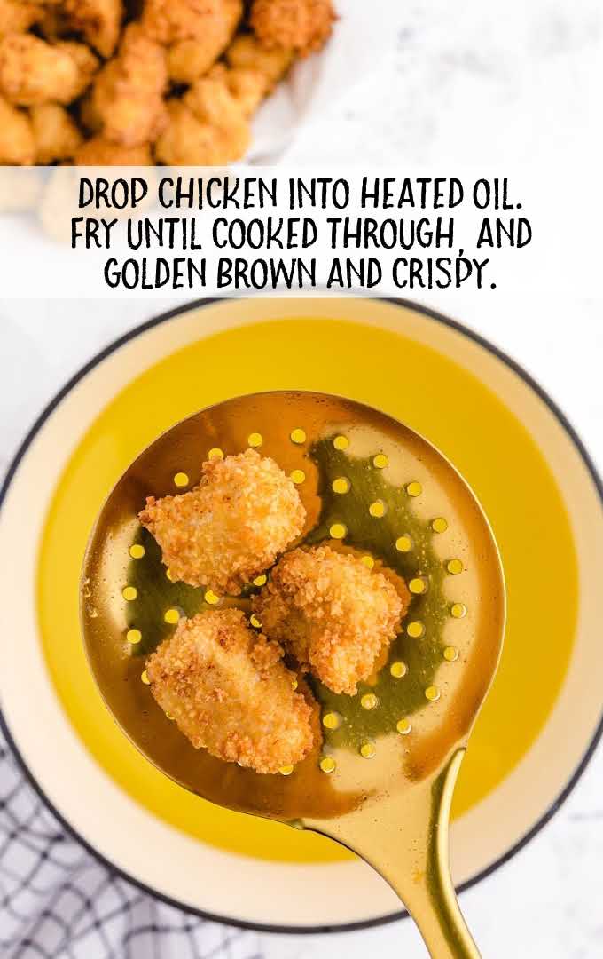 chicken dropped into heated oil